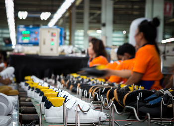 women working on creating shoes in a factory