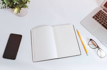 notebook on a desk with a pencil