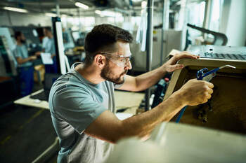 guy with safety glasses assembling equipment