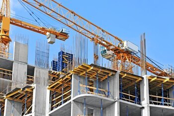 building under construction with large crane overhead